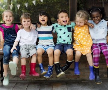 Comp - Kindergarten-kids-friends-arm-around-sitting-smiling
