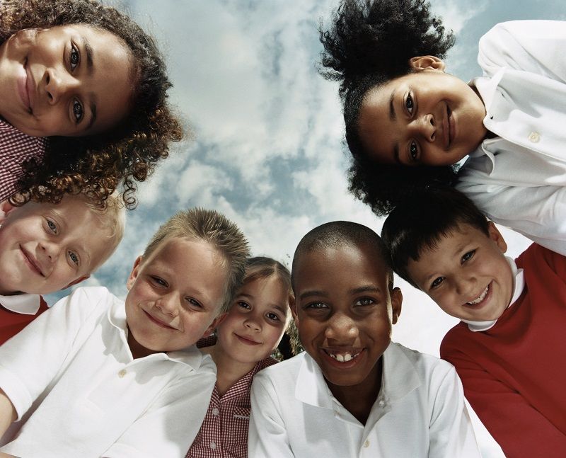 Comp-View-Directly-Below-of-Seven-Primary-School-Children-Huddled-Together-Looking-at-the-Camera